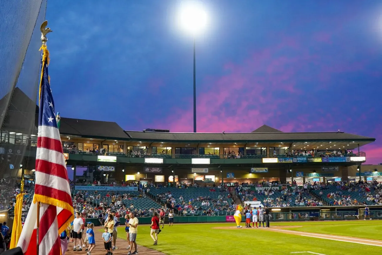 Pink and purple dusk sky over FirstEnergy Park with an American flag in the foreground