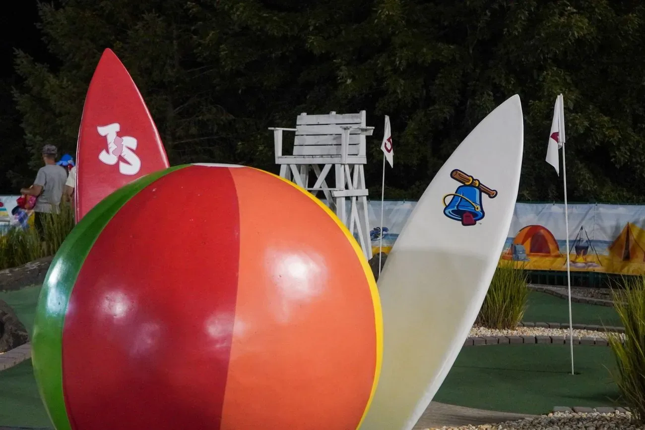Giant beach ball and surfboards on the mini-golf course outside the ballpark
