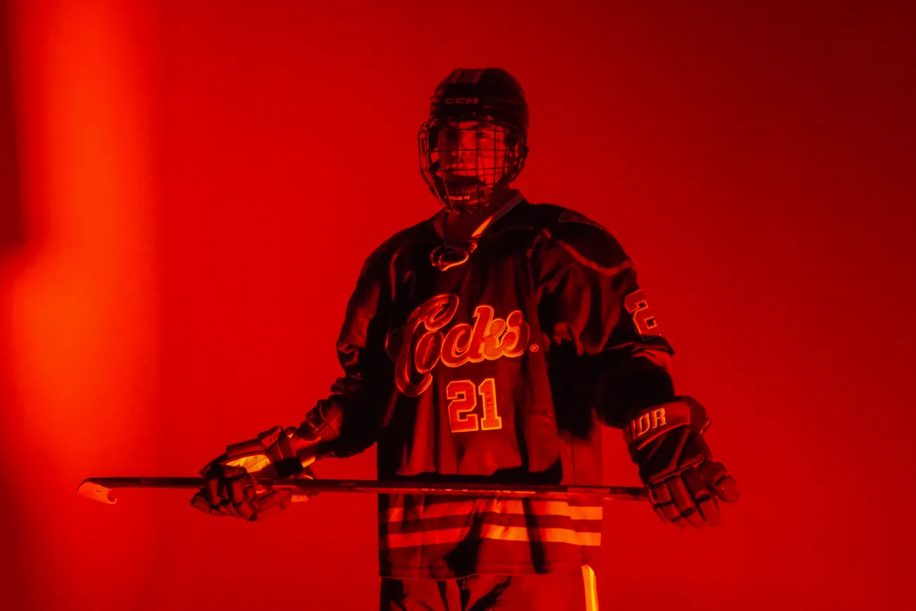 Gamecocks player number 21 holding his stick horizontally across his body in both gloves