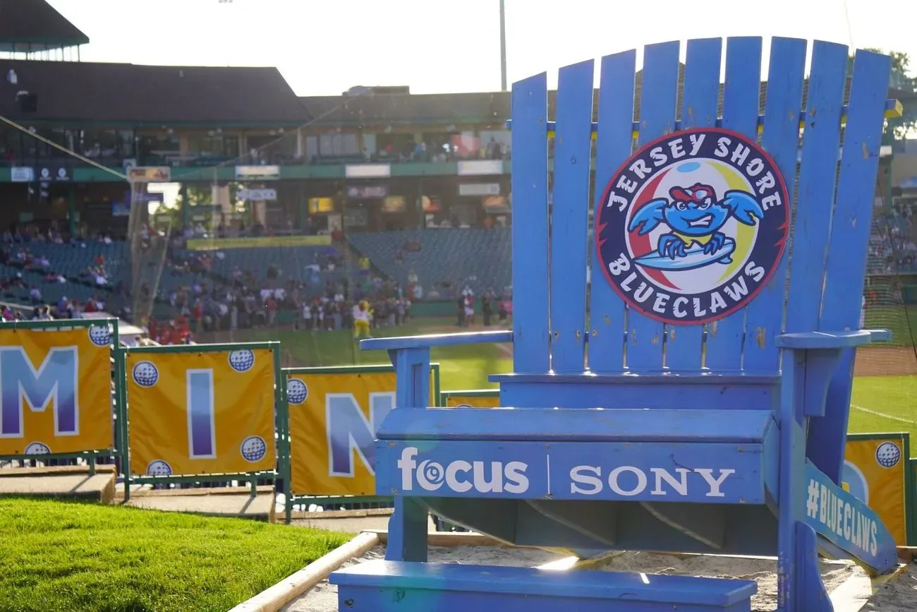 The oversized blue BlueClaws Adirondack chair overlooking the field at dusk
