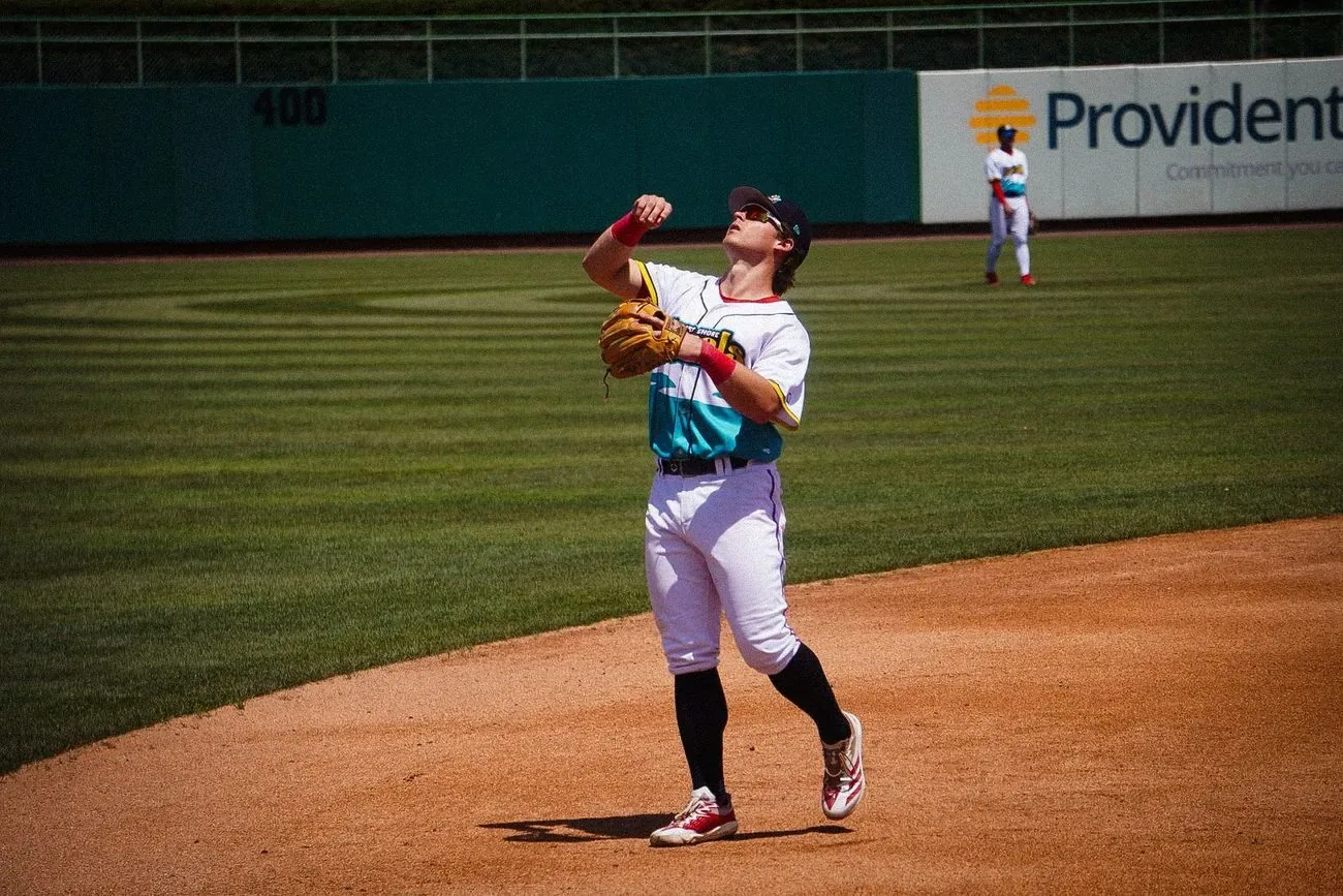 Infielder throwing across the diamond after fielding a ground ball