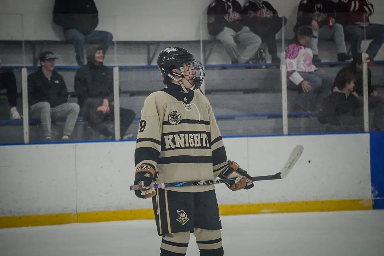 UCF player standing alone along the boards during a stoppage