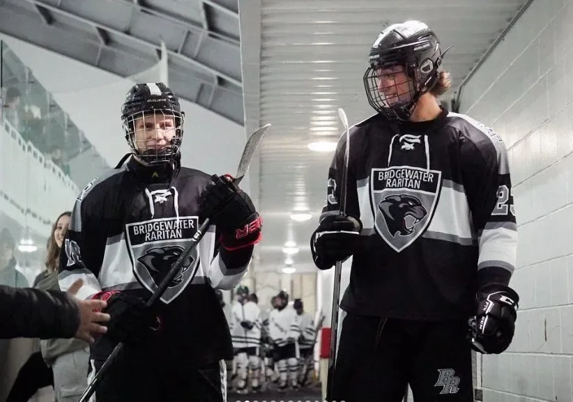 Two Bridgewater Raritan players walking out of the tunnel toward the ice