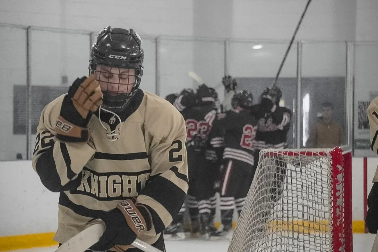 UCF player skating away from a Carolina goal celebration behind the net