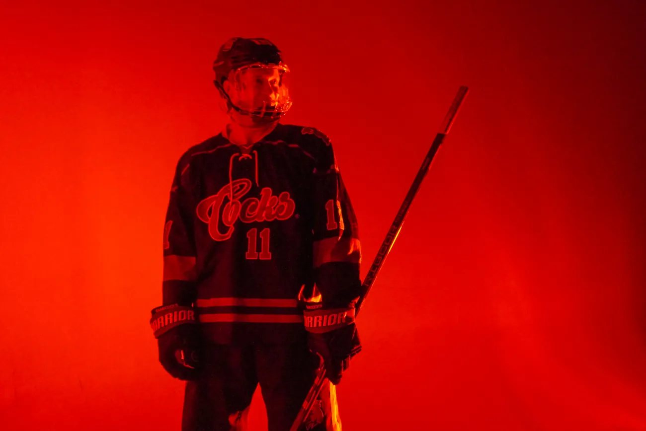 Gamecocks player number 11 square to camera with his stick resting at his side