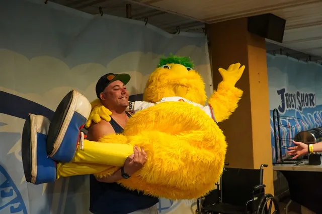 A fan lifting Buster off his feet in a bear hug