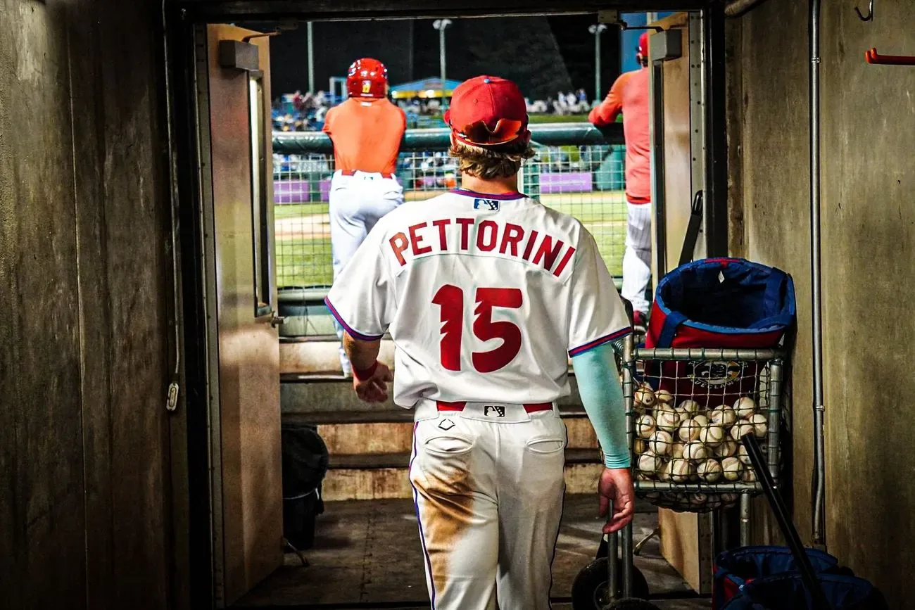 Player Pettorini, number 15, walking up the dugout tunnel steps out toward the field