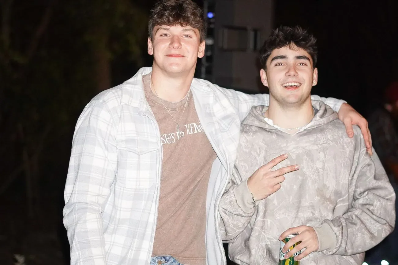 Two friends with arms around each other on a night out
