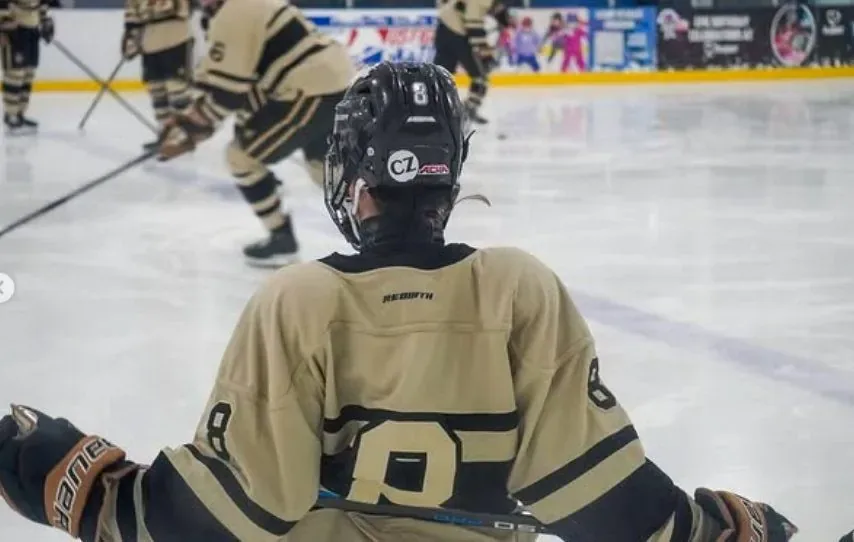 UCF player seen from behind waiting at the faceoff dot