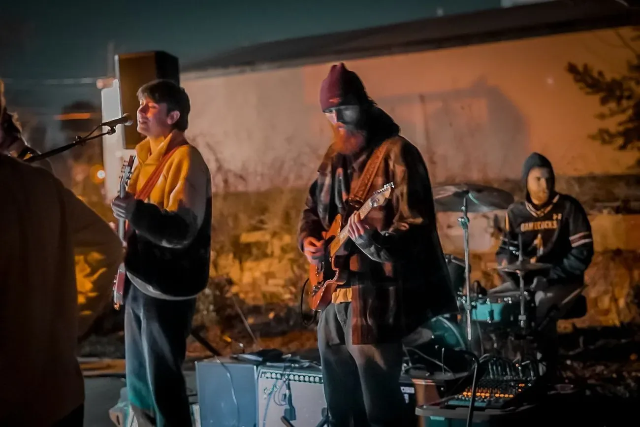 Band playing an outdoor porch set at golden hour